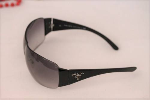 An awesome pair of black Italian made Prada (model SPR22M) ladies sunglasses w/ grey gradient lenses