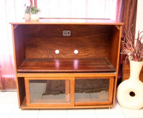 **RS17** A large Teak cabinet w/ fold away serving shelf, glass sliding doors, on original castors