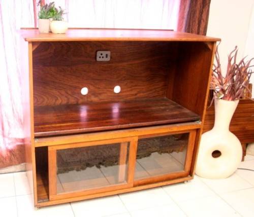 **RS17** A large Teak cabinet w/ fold away serving shelf, glass sliding doors, on original castors