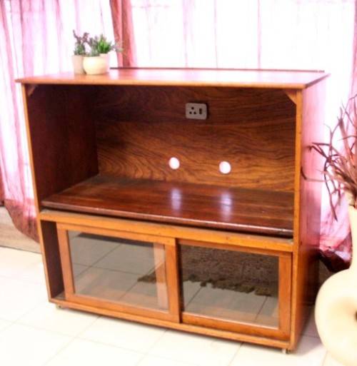 **RS17** A large Teak cabinet w/ fold away serving shelf, glass sliding doors, on original castors