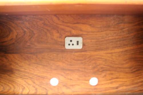 **RS17** A large Teak cabinet w/ fold away serving shelf, glass sliding doors, on original castors