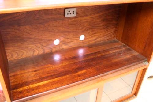 **RS17** A large Teak cabinet w/ fold away serving shelf, glass sliding doors, on original castors