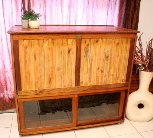 **RS17** A large Teak cabinet w/ fold away serving shelf, glass sliding doors, on original castors