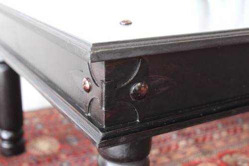 A stunning Indonesian Teak coffee table with clean lines, thick turned legs and carved detailing