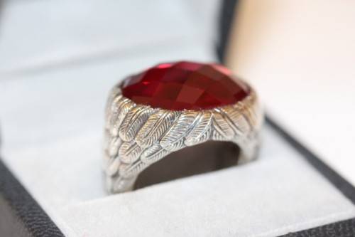 A stunning sterling silver ring with a huge faceted garnet centre stone and exquisite detailing