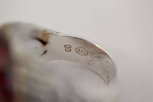 A stunning sterling silver ring with a huge faceted garnet centre stone and exquisite detailing