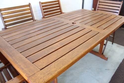 A fabulous 6-seater solid Sapele wood, all weather "Outback" outdoor patio table with 6 armchairs