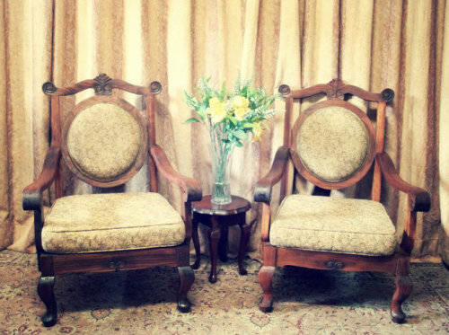 Two gorgeous antique Victorian Stinkwood arm chairs w carved detailing & floral upholstery. Price/
