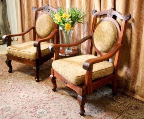 Two gorgeous antique Victorian Stinkwood arm chairs w carved detailing & floral upholstery. Price/