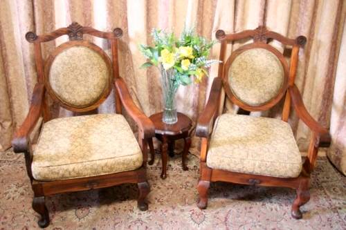 Two gorgeous antique Victorian Stinkwood arm chairs w carved detailing & floral upholstery. Price/