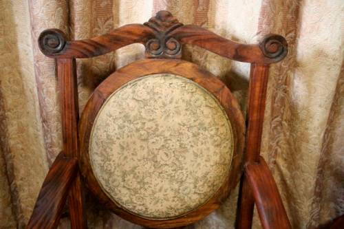Two gorgeous antique Victorian Stinkwood arm chairs w carved detailing & floral upholstery. Price/