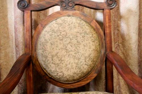 Two gorgeous antique Victorian Stinkwood arm chairs w carved detailing & floral upholstery. Price/