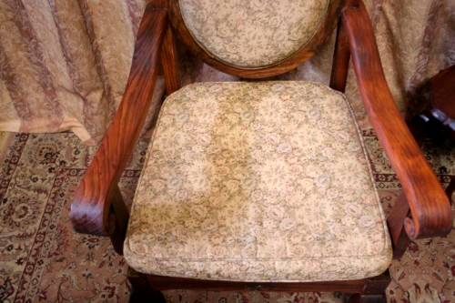Two gorgeous antique Victorian Stinkwood arm chairs w carved detailing & floral upholstery. Price/