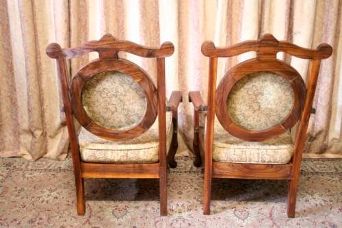 Two gorgeous antique Victorian Stinkwood arm chairs w carved detailing & floral upholstery. Price/