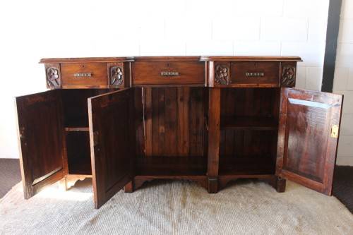 A gorgeous Victorian heavily carved solid Oak three-door side server with loads of drawer space!