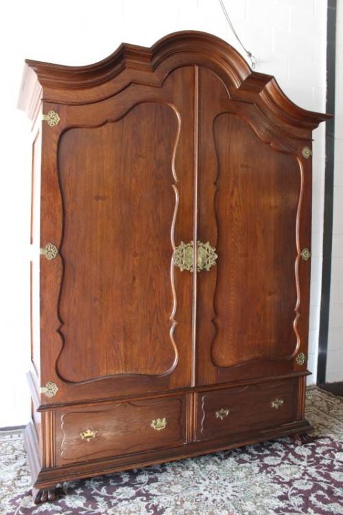 An impressive antique solid honeyed oak gabled double-door wardrobe w drawers & brass embellishments