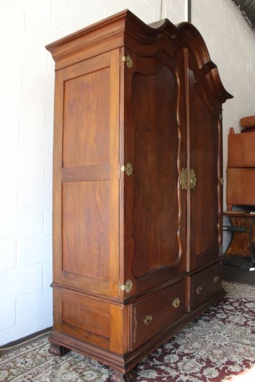 An impressive antique solid honeyed oak gabled double-door wardrobe w drawers & brass embellishments