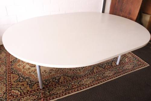 A large oval modern styled, grey painted 8 to 10-seater boardroom table on a sturdy metal frame