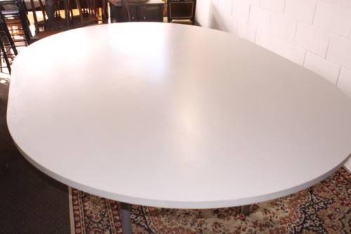 A large oval modern styled, grey painted 8 to 10-seater boardroom table on a sturdy metal frame
