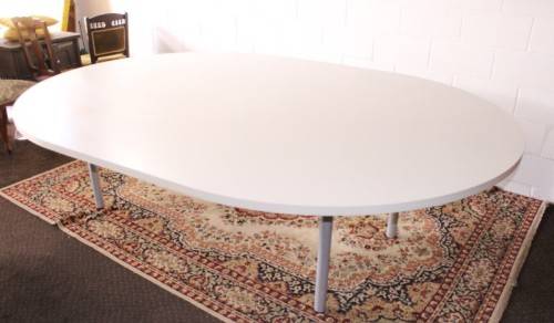 A large oval modern styled, grey painted 8 to 10-seater boardroom table on a sturdy metal frame