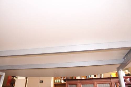 A large oval modern styled, grey painted 8 to 10-seater boardroom table on a sturdy metal frame