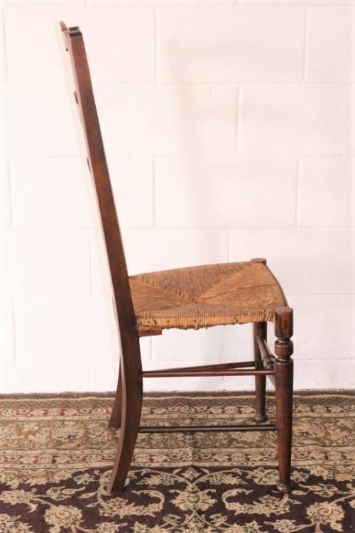 **RS17** A wonderful antique oak ladder-back dining/ occasional chair with a woven grass seat