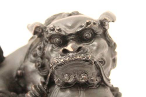 An awesome black oriental resin foo dog/ temple lion ornament