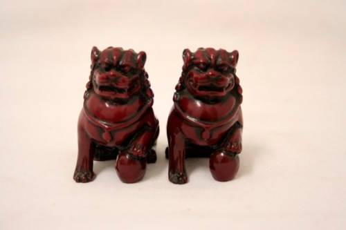 A gorgeous pair of cinnabar-red resin foo dogs/ temple lions in lovely condition