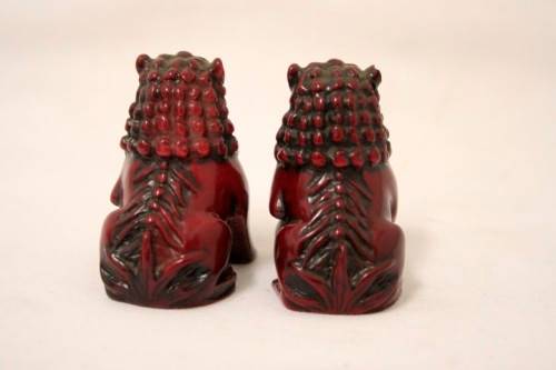 A gorgeous pair of cinnabar-red resin foo dogs/ temple lions in lovely condition