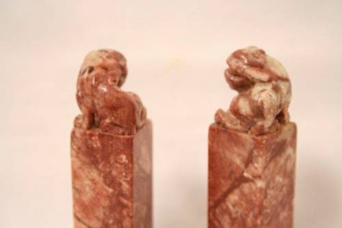 An incredible boxed pair of hand carved red-marble Feng Shui Foo Dog/ Temple Lion ornaments