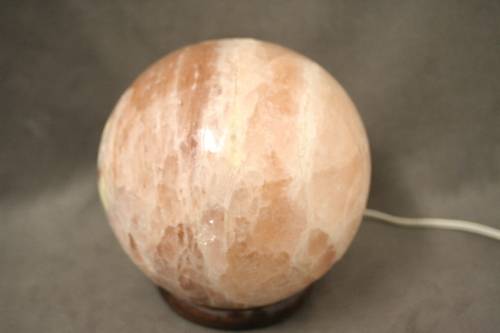 An amazing Himalayan Crystal Salt lamp on a wooden base in complete working condition