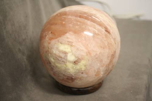 An amazing Himalayan Crystal Salt lamp on a wooden base in complete working condition