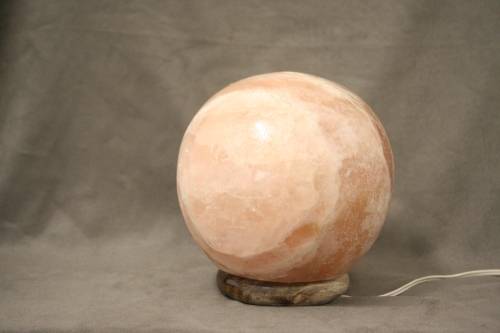 An amazing Himalayan Crystal Salt lamp on a wooden base in complete working condition