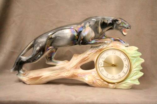 A gorgeous, decorative German made porcelain Jaguar wind up clock.