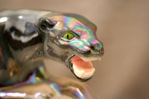 A gorgeous, decorative German made porcelain Jaguar wind up clock.