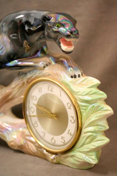A gorgeous, decorative German made porcelain Jaguar wind up clock.