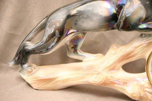 A gorgeous, decorative German made porcelain Jaguar wind up clock.