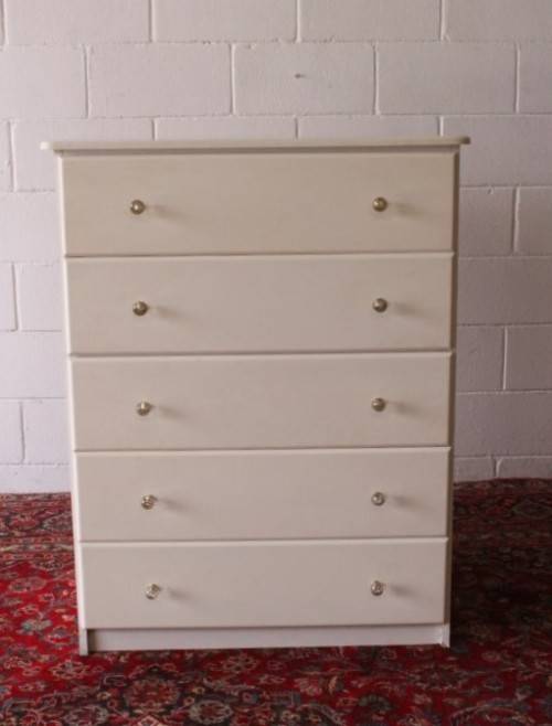 A stunning white 5-drawer chest of drawers with crystal/ glass? handles and ample storage space