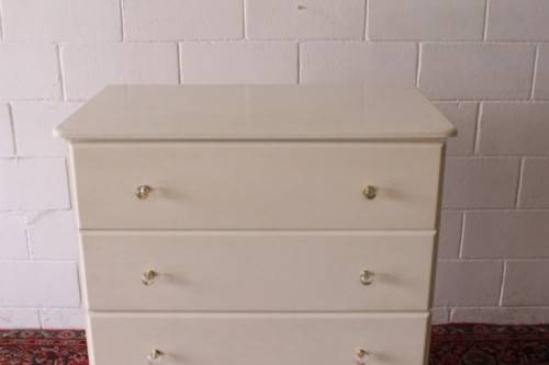 A stunning white 5-drawer chest of drawers with crystal/ glass? handles and ample storage space