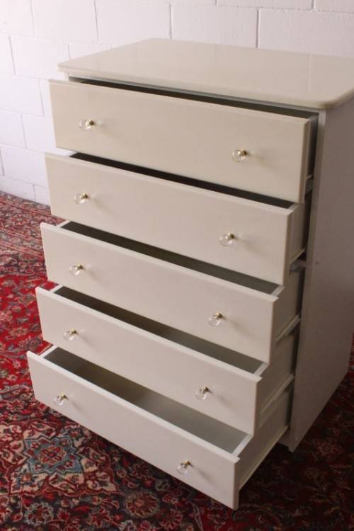 A stunning white 5-drawer chest of drawers with crystal/ glass? handles and ample storage space