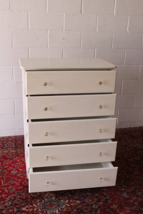 A stunning white 5-drawer chest of drawers with crystal/ glass? handles and ample storage space