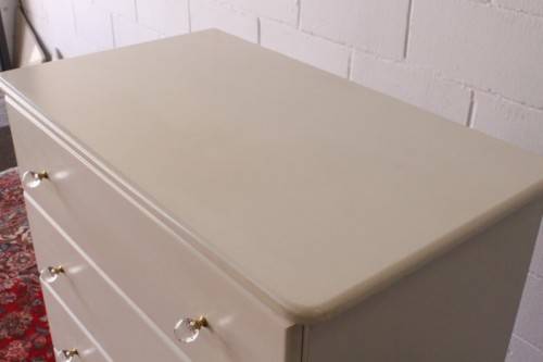 A stunning white 5-drawer chest of drawers with crystal/ glass? handles and ample storage space