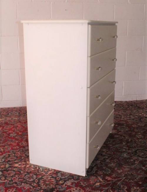 A stunning white 5-drawer chest of drawers with crystal/ glass? handles and ample storage space