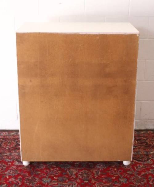 A tall 4-over-2 white painted chest of drawers with brass handles and ample storage space