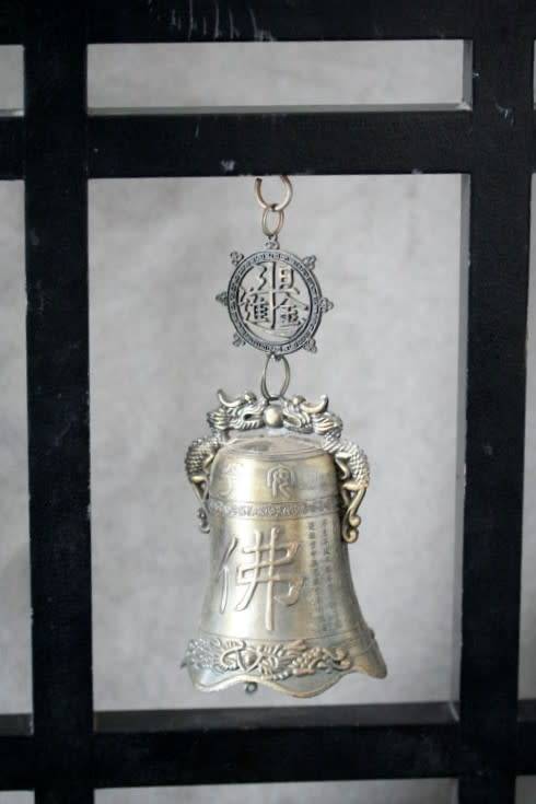 An amazing vintage Chinese bell on a wood stand with lovely detailing.