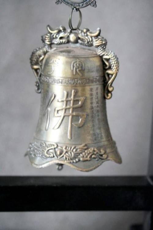 An amazing vintage Chinese bell on a wood stand with lovely detailing.