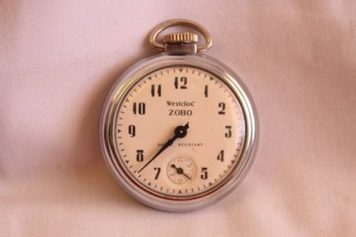 A gorgeous antique Canadian made Westclox Zobo chrome plated open-face pocket watch with a fob chain
