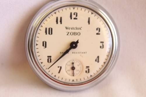 A gorgeous antique Canadian made Westclox Zobo chrome plated open-face pocket watch with a fob chain