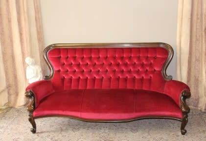 A gorgeous antique Victorian 3 seater settee couch w carved detailing and period style upholstery.