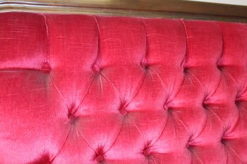 A gorgeous antique Victorian 3 seater settee couch w carved detailing and period style upholstery.